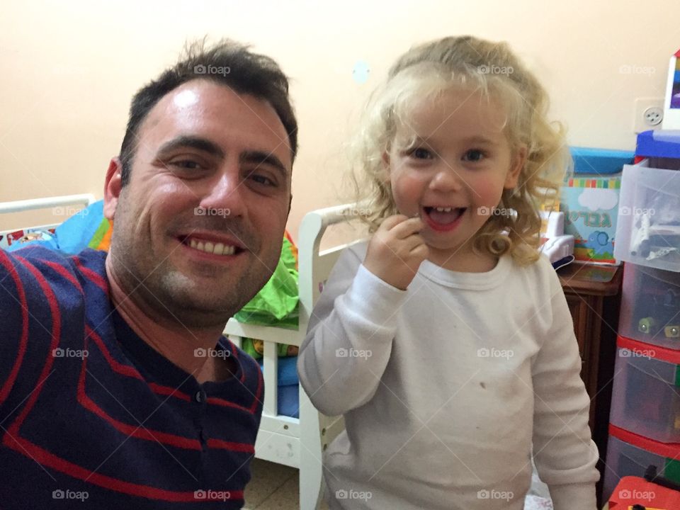 Happy father and daughter taking selfie