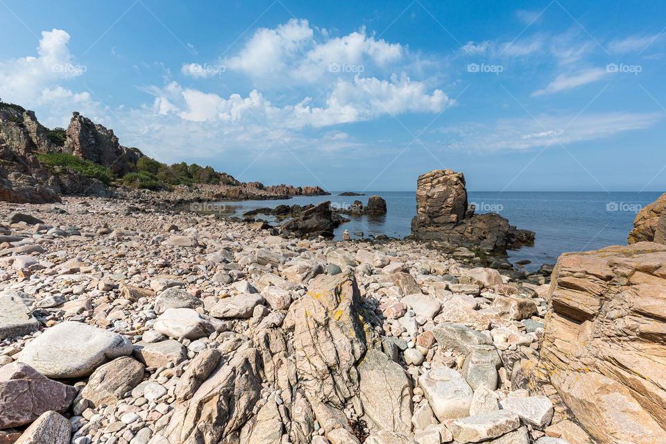 Rocky coast and cliffs of Hovs hallar by the ocean on the west coast of Sweden on sunny day with blue sky 