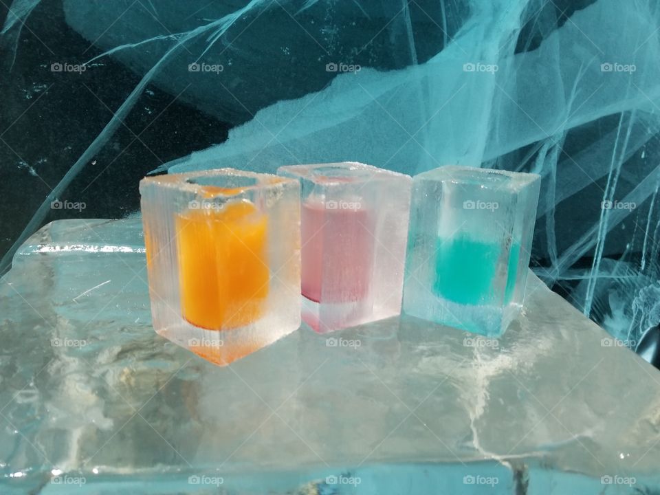 Ice shot glasses with colorful mixed drinks and cocktails