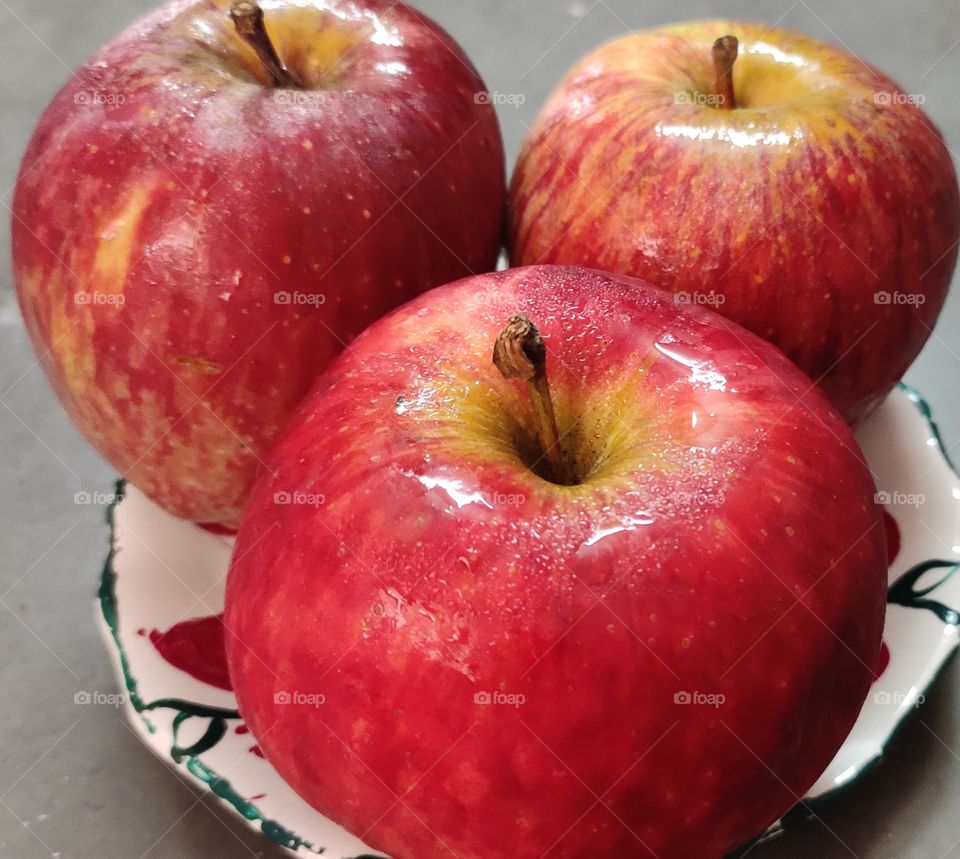 bunch of fresh red apples in a white plate