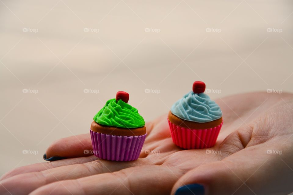 Hand of woman holding small muffins