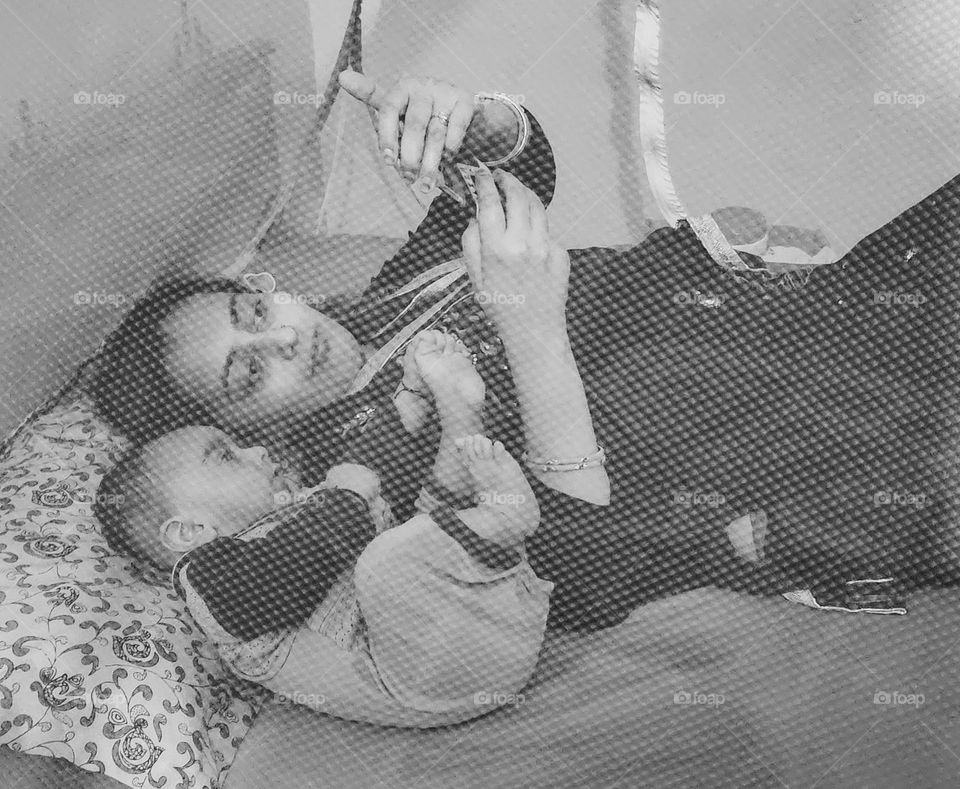 Mother and son in a mosquito net enjoying happy moments