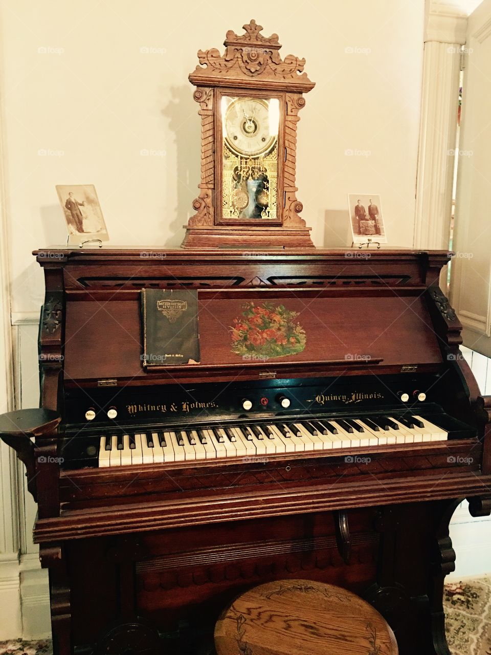 Antique Piano. Wooden. Old. Music. Keys. Clock. Picture frames. Beautiful antique. Historical home.