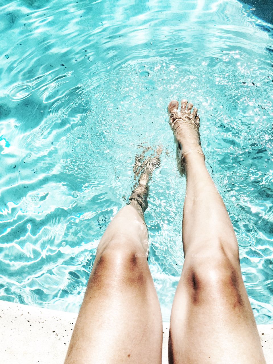 Woman feet at the swimming pool