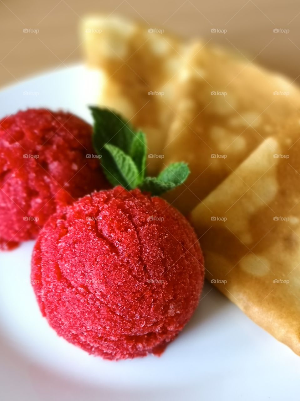 Homemade pancakes with strawberry sorbet and mint