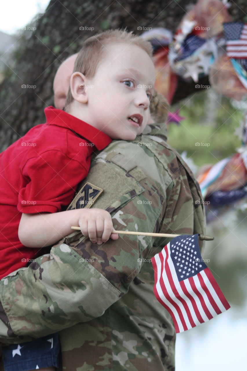 Father carrying his son