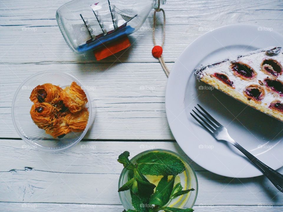 cherry cake, lemonade with mint on the table