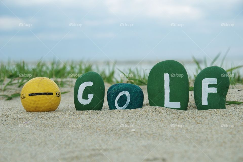 Golf concept on colourful stones