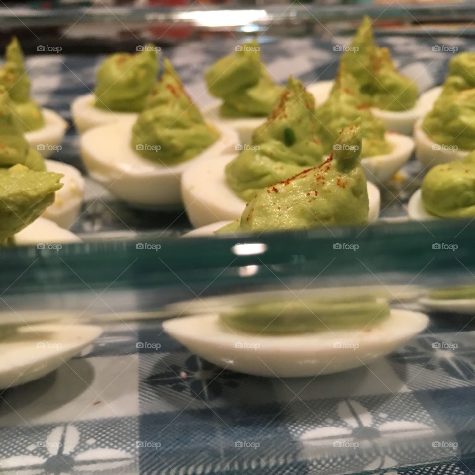 Avocado deviled eggs, with paprika sprinkled on top. 