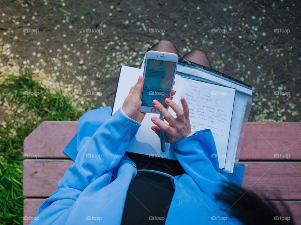 Hands of business woman using mobile device 