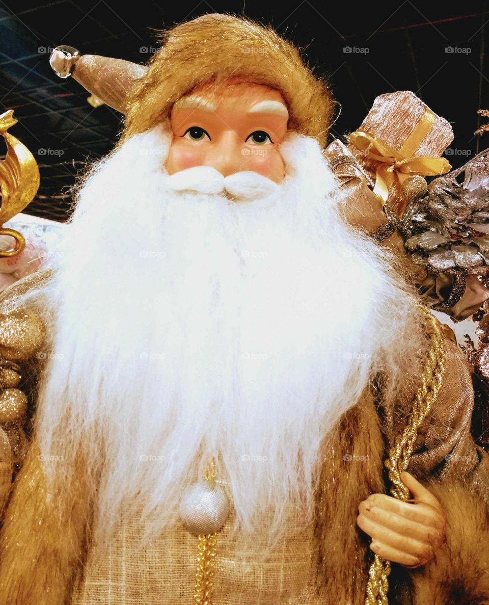 A Santa decoration in fur and gold trim