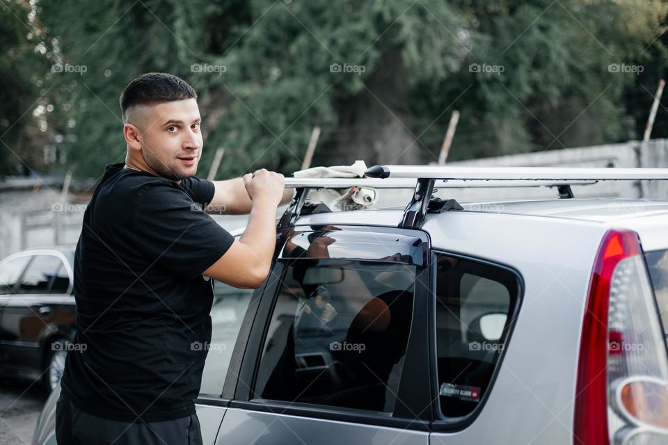 Man washing car , natural portrait
