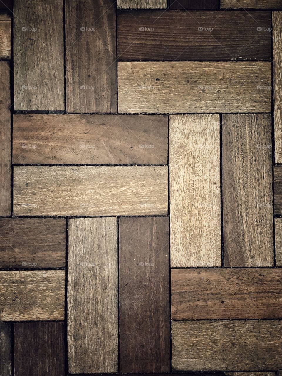 A beautiful pattern in the waiting room floor. Retangular pieces of wood creating a great pattern on the floor.