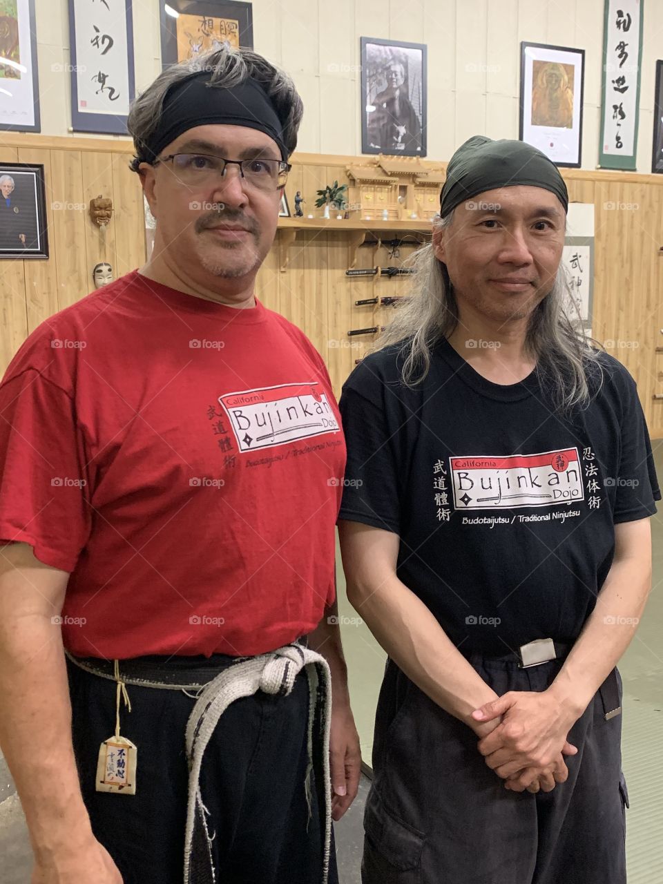 The sensei standing next to one of his loyal students does stand out in the somewhat bright red shirt.