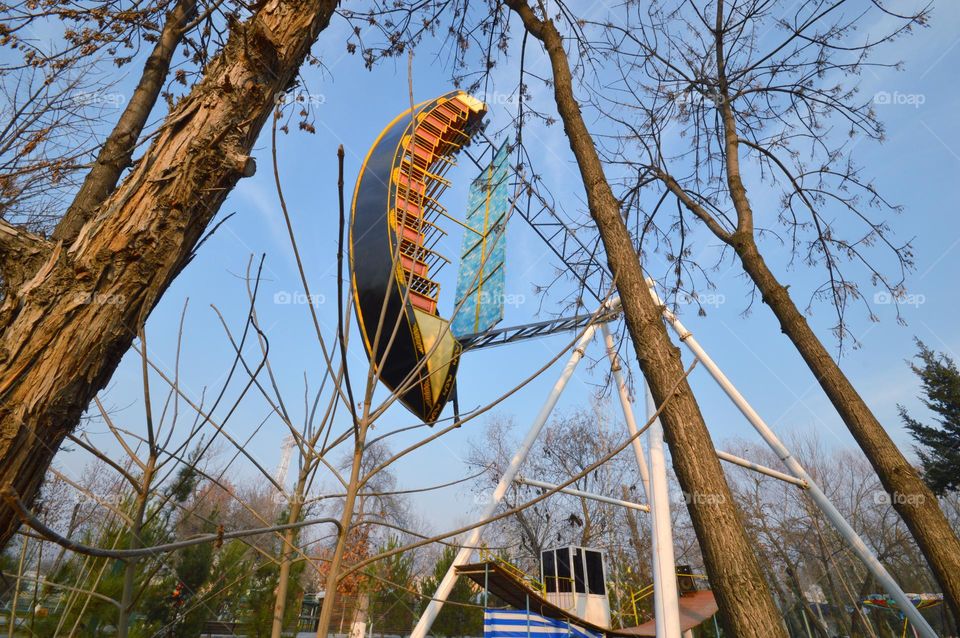 Viking boat swing in the amusement park at the peak of takeoff