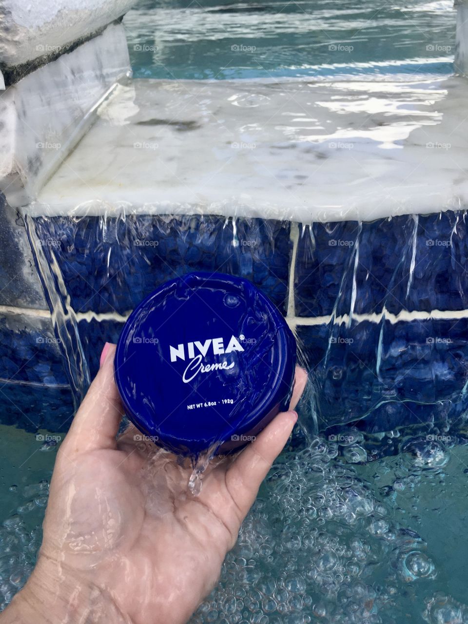 Nivea creme held by hand