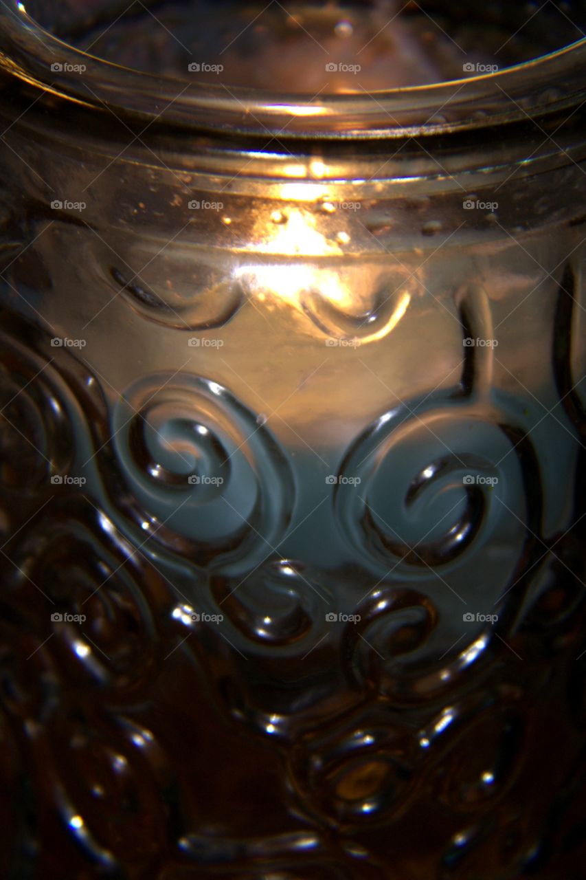 Burning Candle Through Aqua Colored Glass