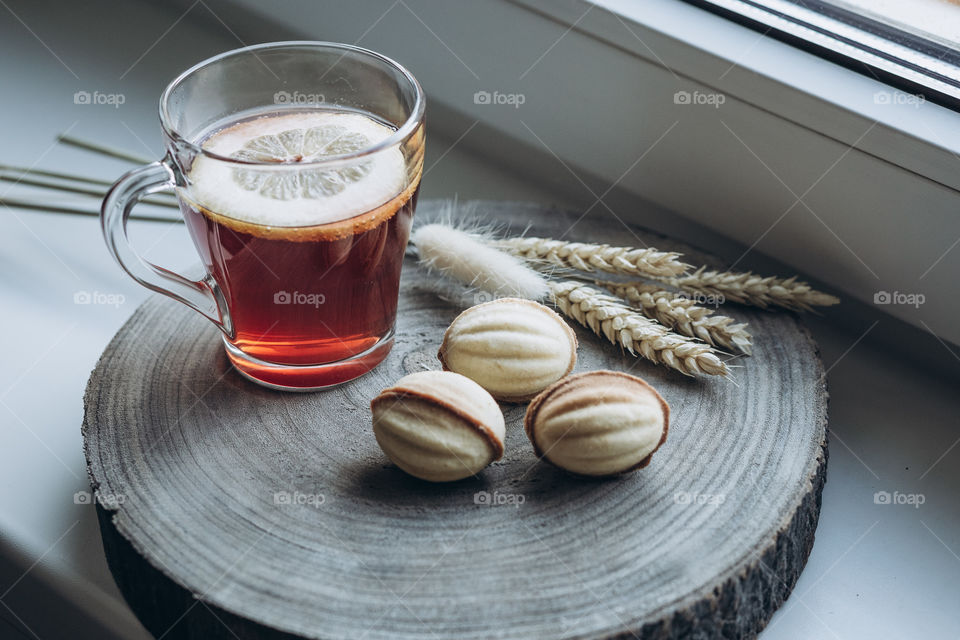 tea with lemon and sweet cookies nuts