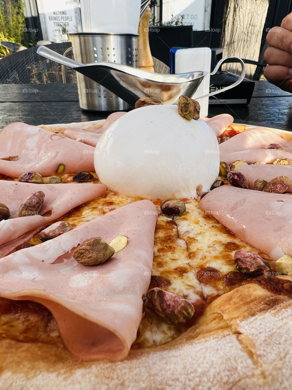 Pizza with mortadella, pistachios and buffalo cheese 