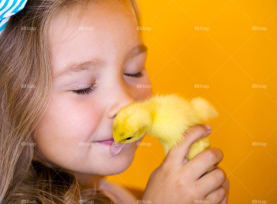 Cute girl with duck. Cute baby with amazing duck