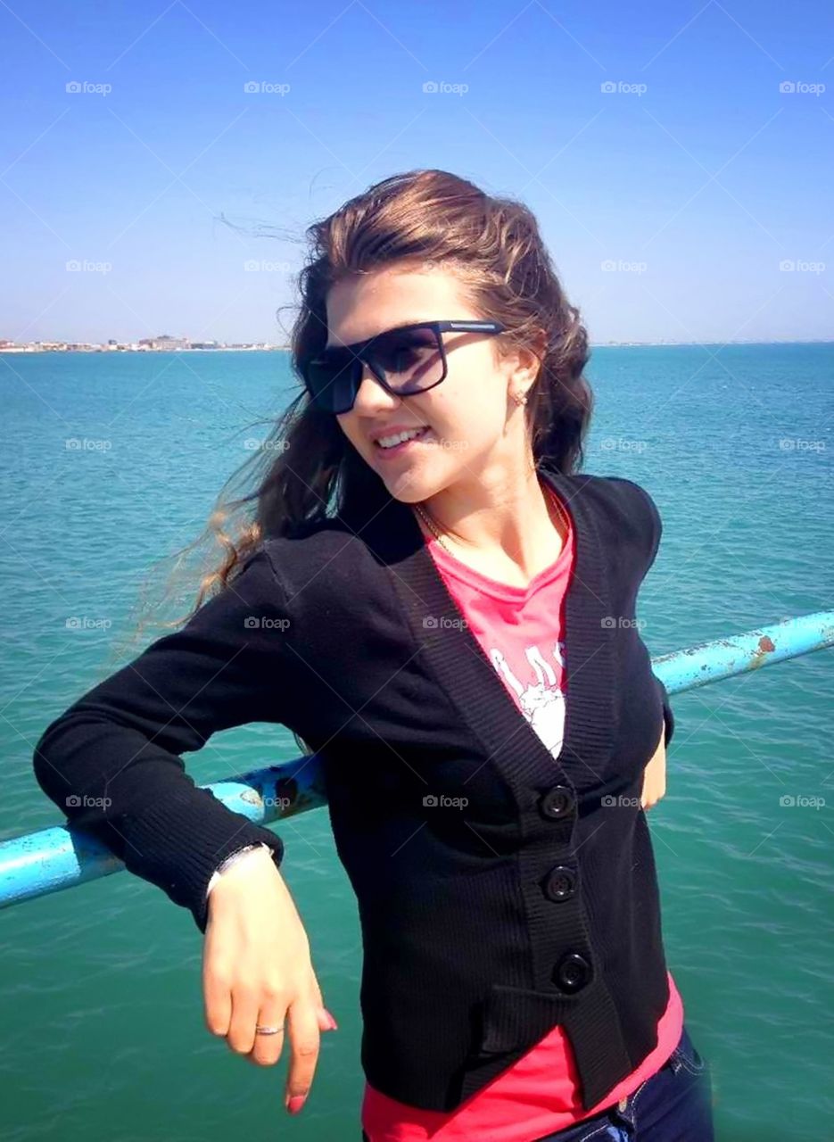 Beautiful girl is enjoying spring. Beautiful girl is smiling and is enjoying spring near the sea