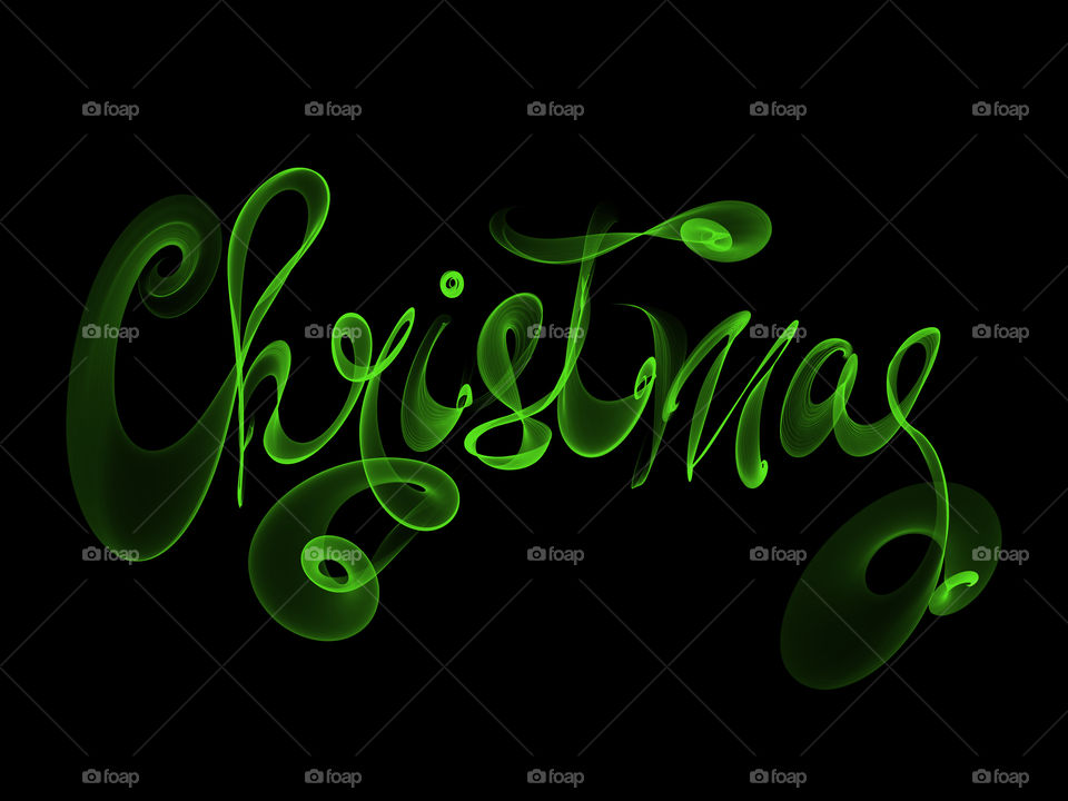 Christmas word lettering written with green fire flame or smoke on black background