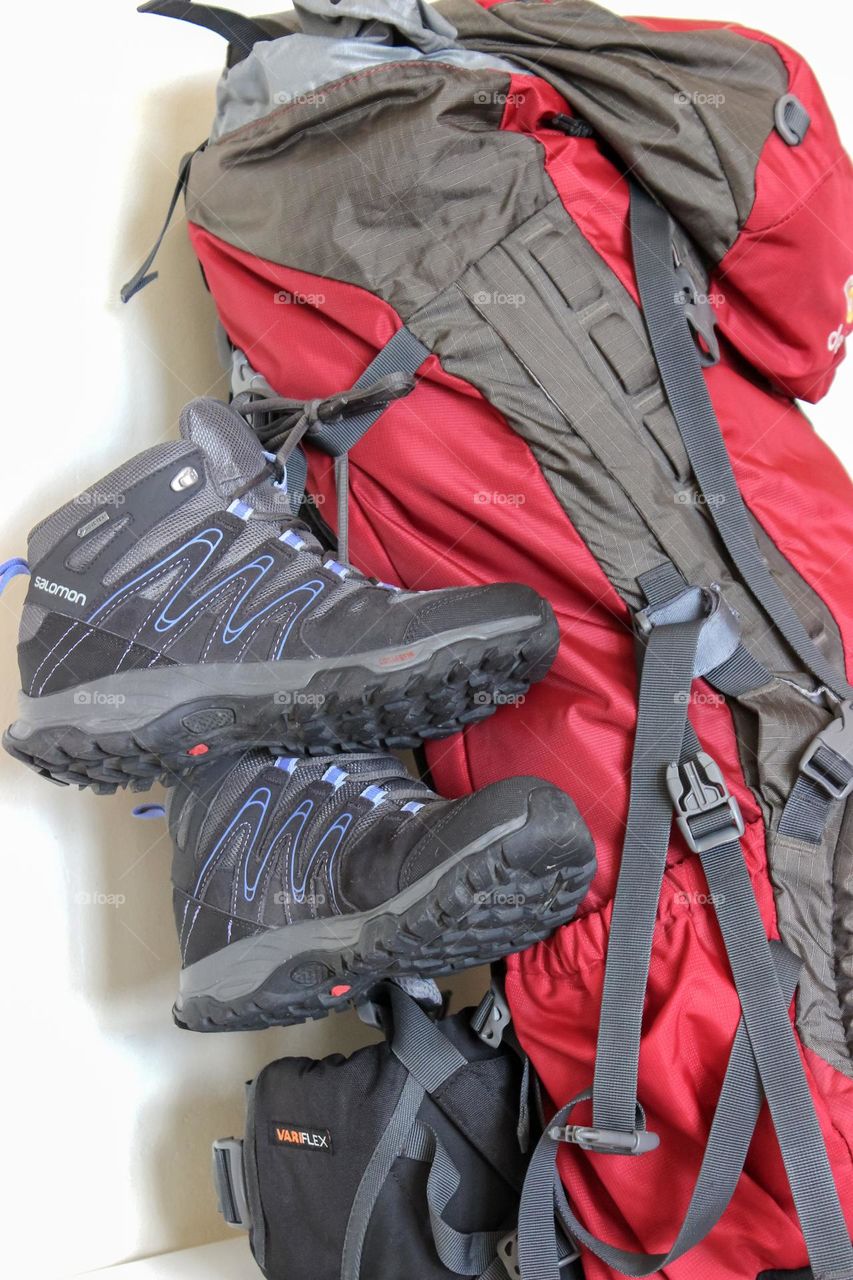 Sneakers hanged in backpack ready for hiking