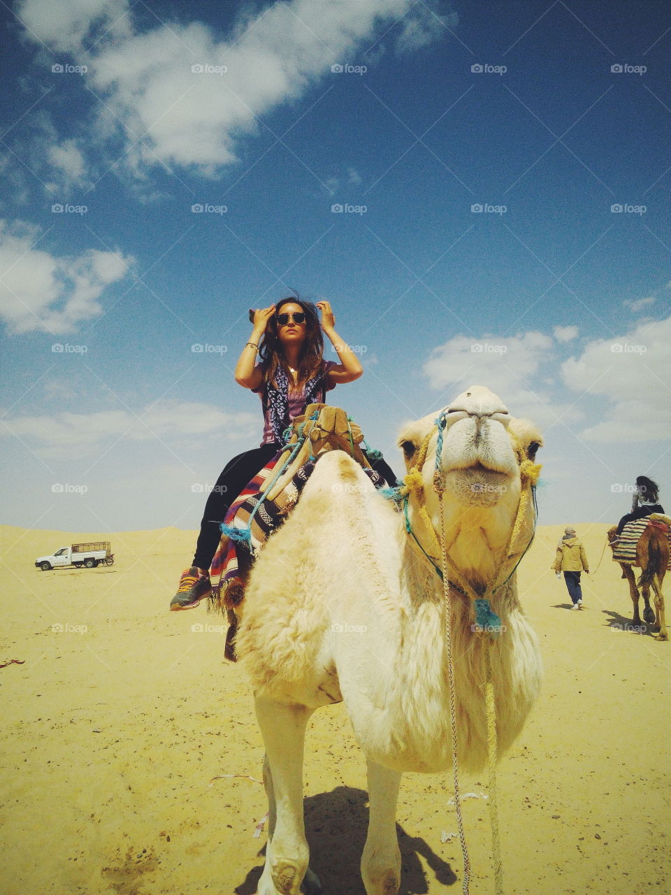 Woman on camel ride in desert