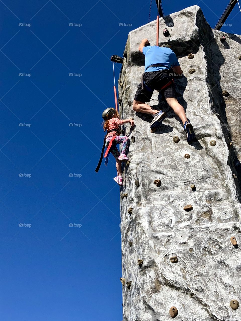 Scaling the rock wall looks easy from down here- this five-year-old nimbly keeps up with an older experienced climber. Lol! 