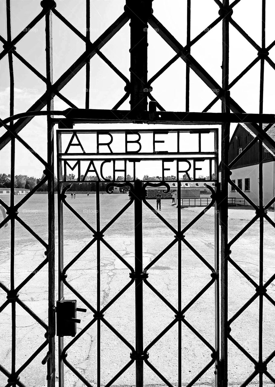 Arbeit macht frei / Dachau concentration camp / entrance door to the first concentration capm / black and white photography