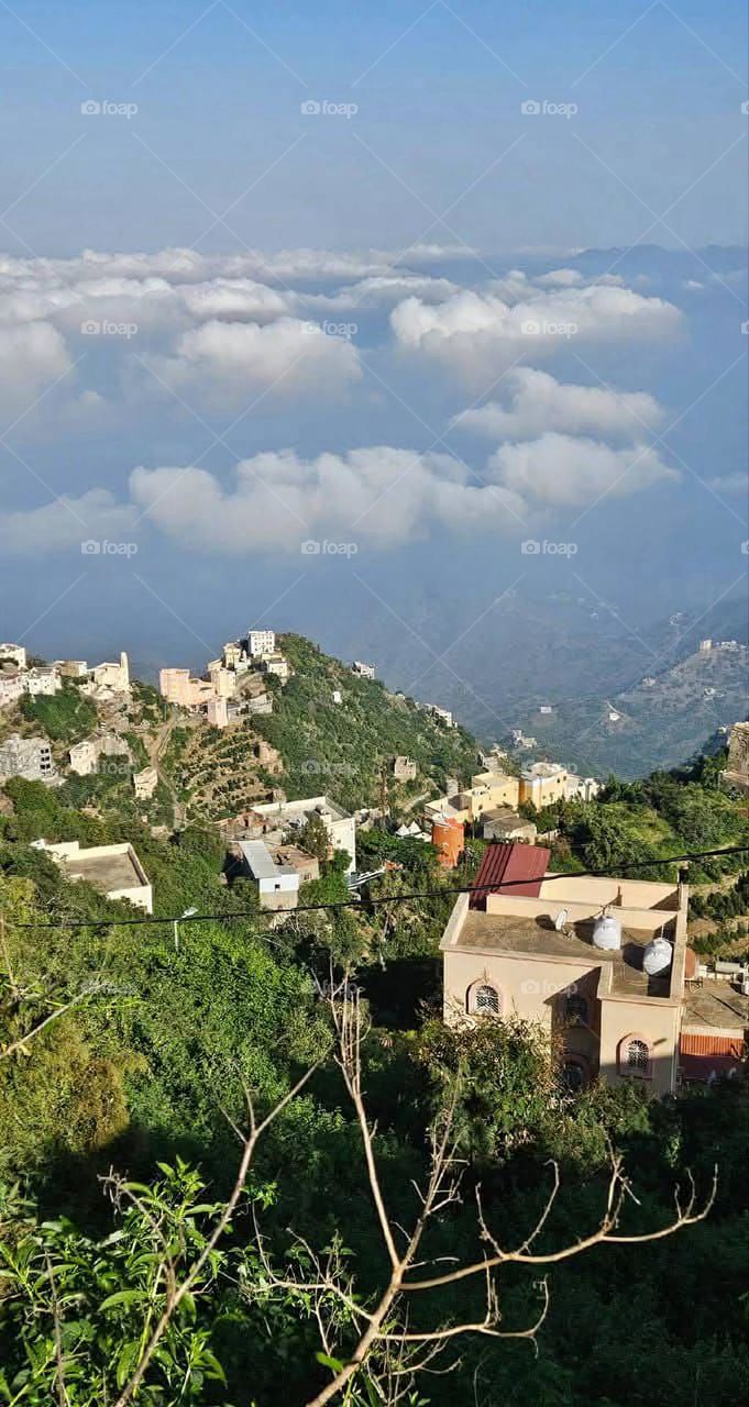 A stunning view of green mountains covered in fog in Yemen