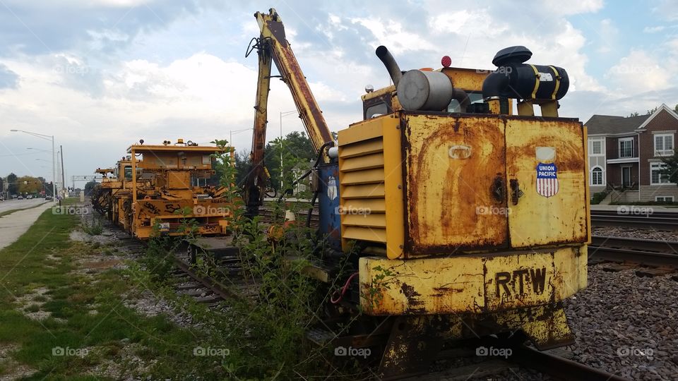 bordered by new construction, these old railcars stand