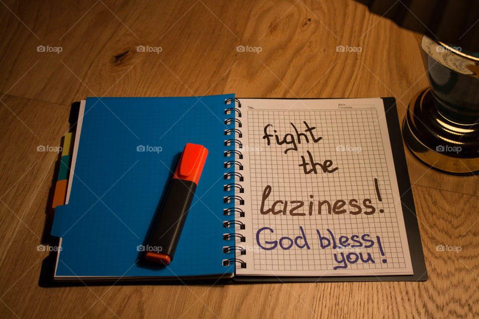 Motivational letter in a notebook on the desktop under the light of a lamp