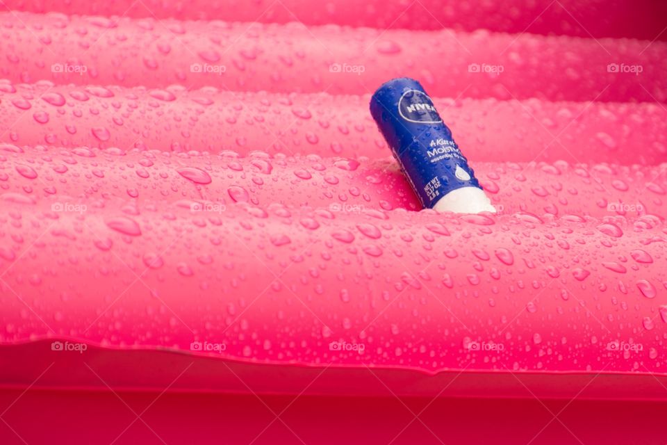 A Nivea lip balm on a wet air bed 
