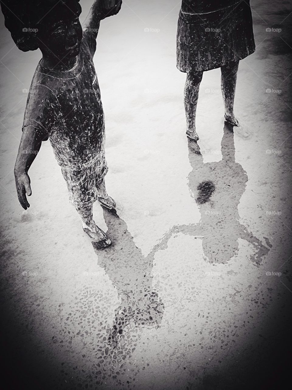 Reflections of statues in water 