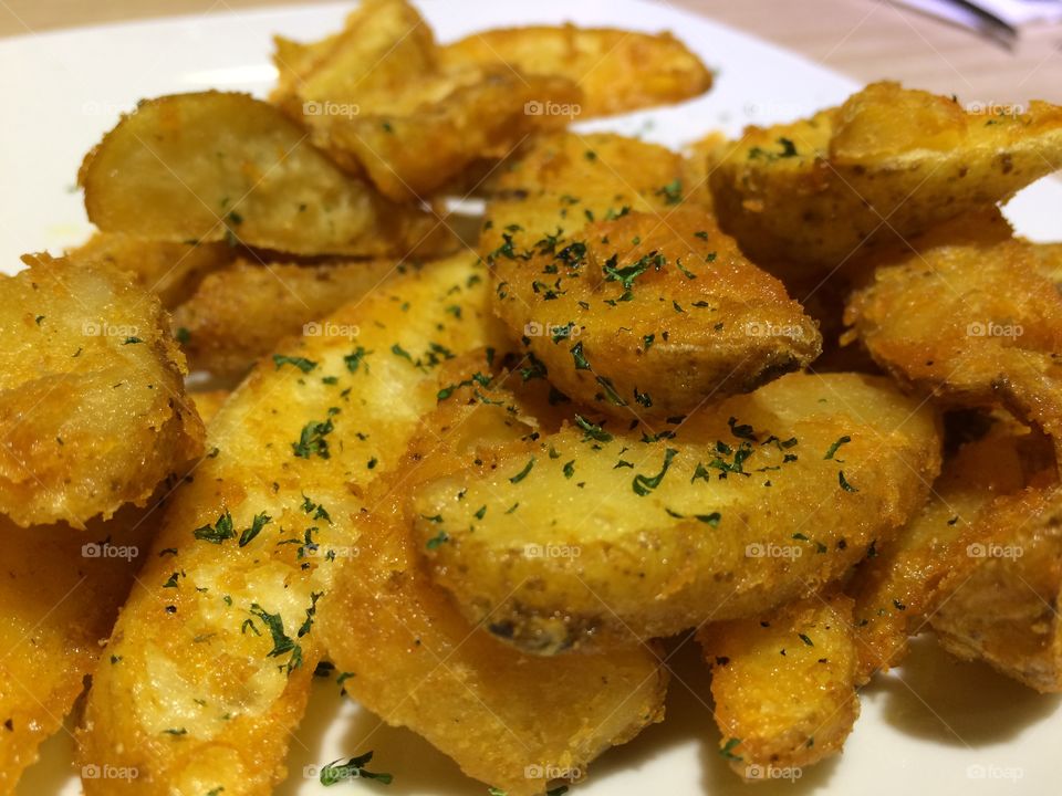 Fried potato with its mashed greeny leaves in a steak restaurant. 