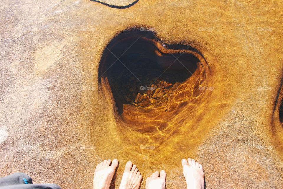 The shape of a heart in the rock of a river