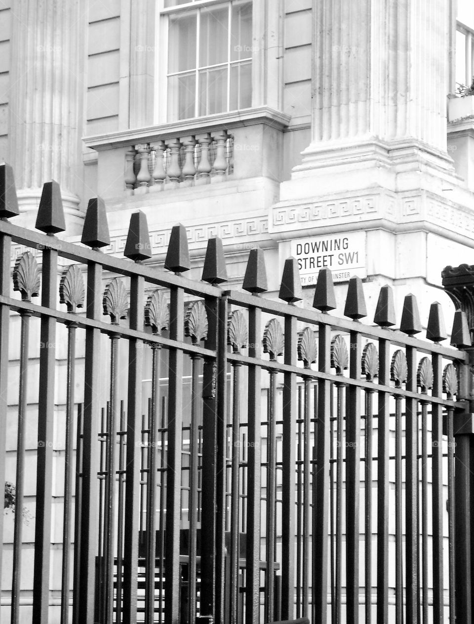 Iron fence and building. Photo taken on London on Downing Street.  Black and white.
