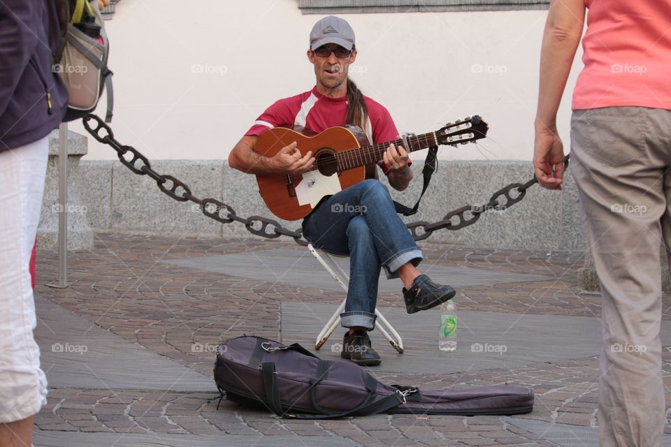 Street Musician. Street musician reacts to the camera as he entertains the crowd 