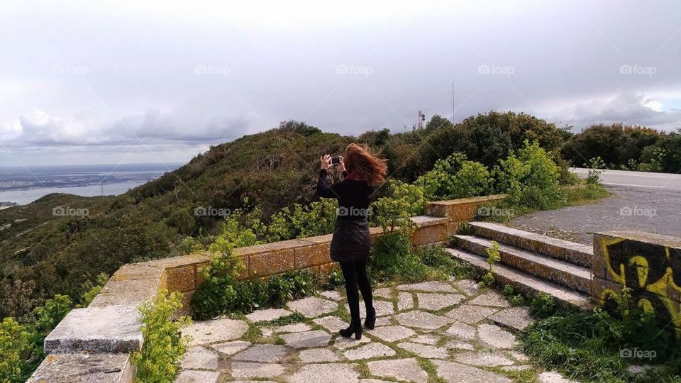 Girl shooting photos of landscape 