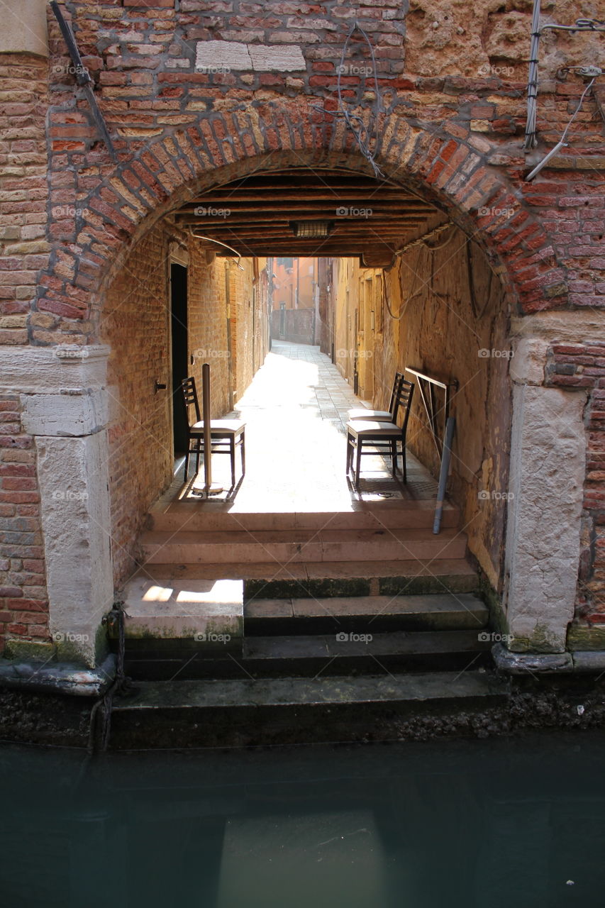 Chairs under arcade · Venice