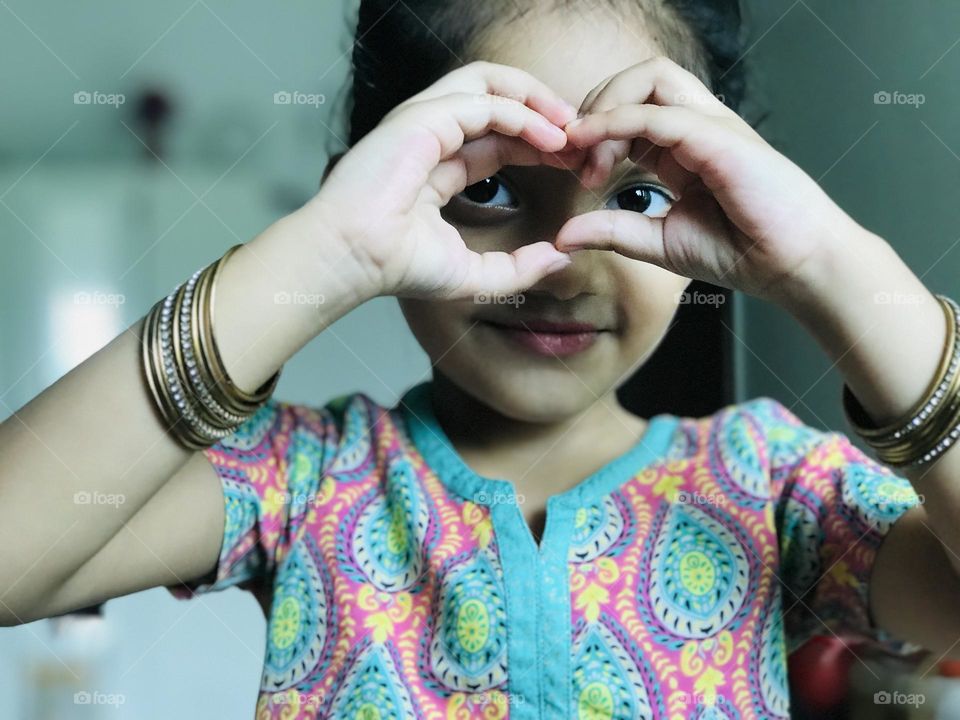 Cute Indian baby girl wear bangles in her hand