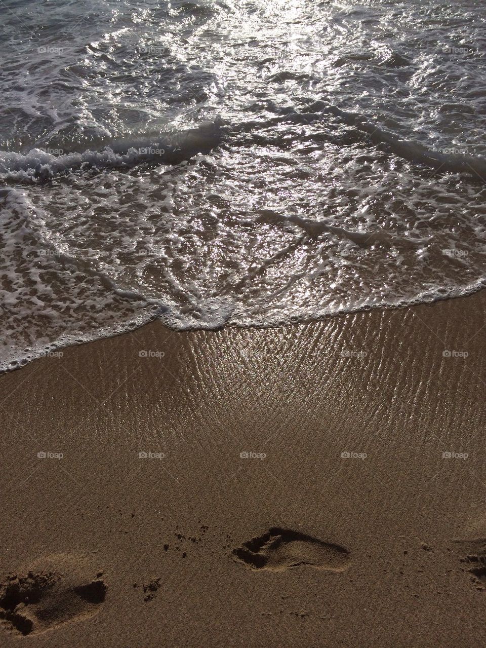 Footprints on beach in the Hawaii