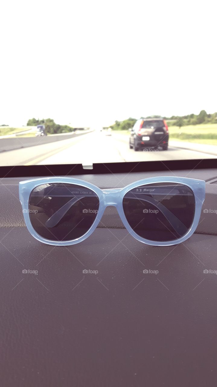 Faded sunglasses on a road trip