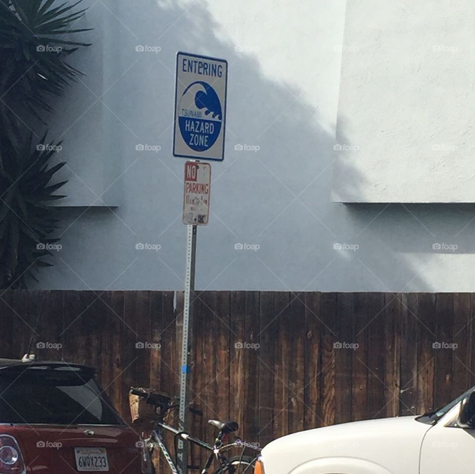 Sign on the Way to the Beach. Sign showing the hazards of big waves and heavy winds.