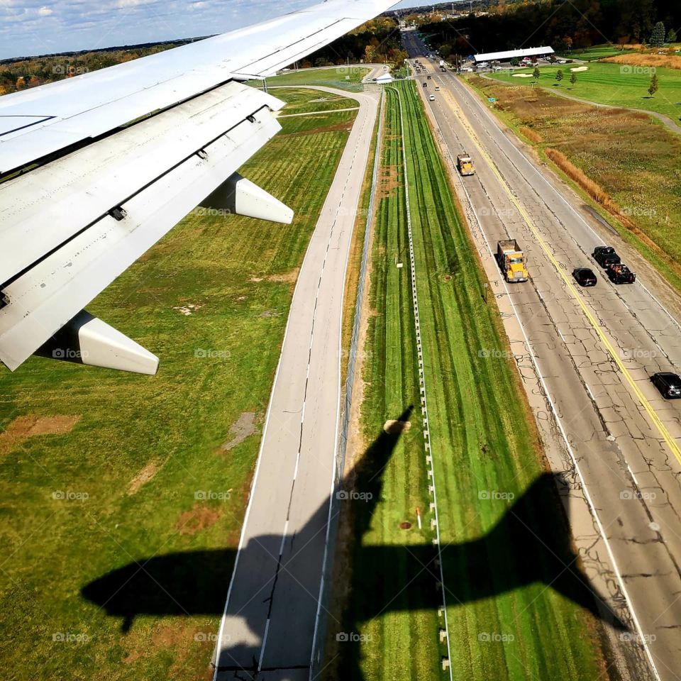 The Southwest Airlines 737 is reflected as a shadow while on final approach