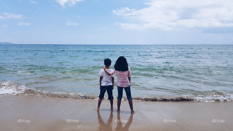 siblings at the beach