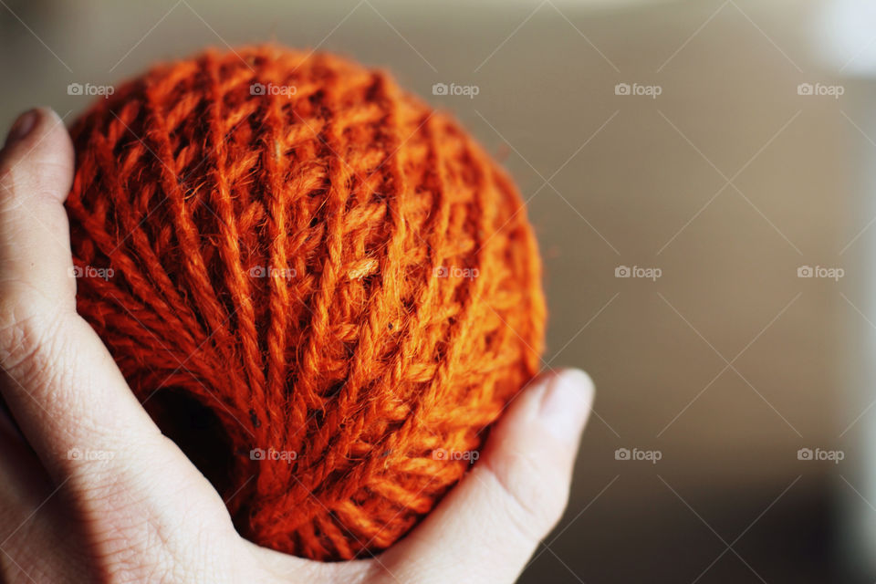 Close-up of hand holding jute rope ball
