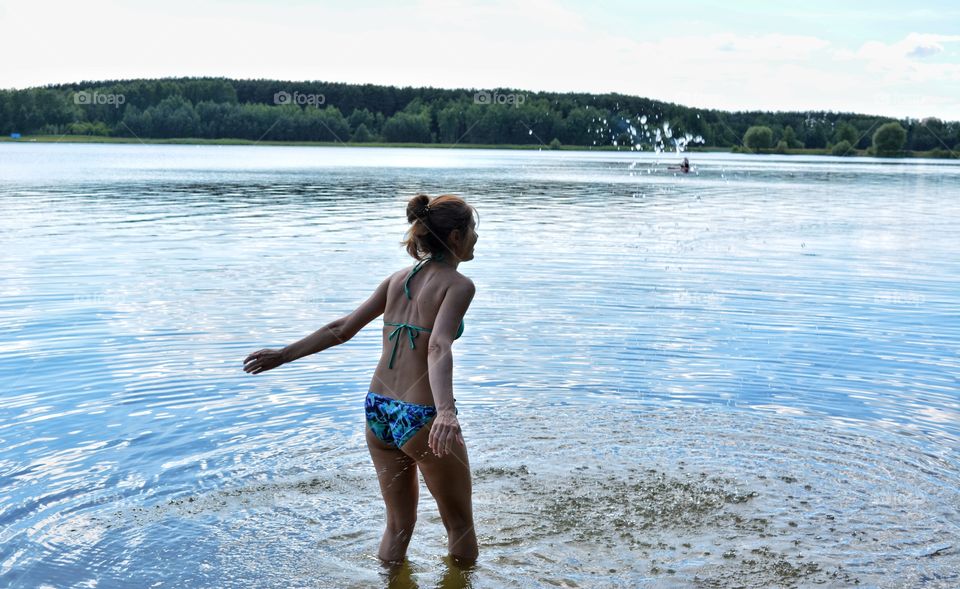 splash water lake girl relaxing on a nature summer heat, summer vacation