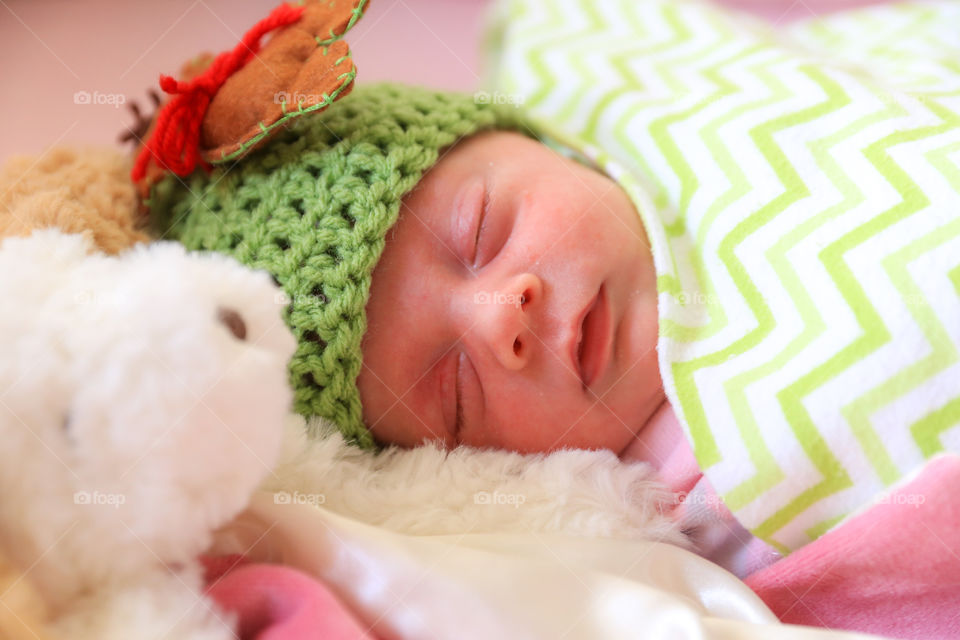 Newborn baby sleeping on bed